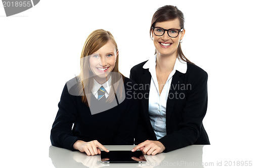 Image of Tutor and student duo operating tablet pc