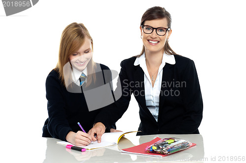 Image of Bespectacled teacher pointing out the mistakes