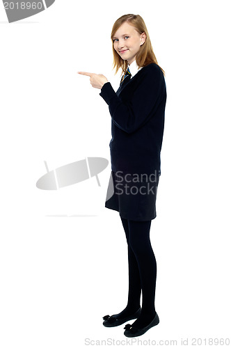 Image of Student standing sideways and pointing forward