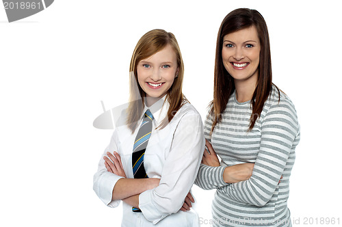 Image of Beautiful mom and daughter posing with confidence