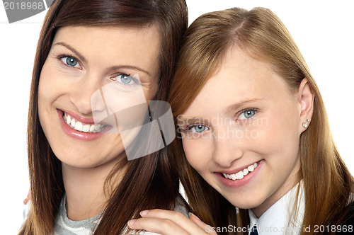 Image of Closeup of mom and daughter flashing a smile