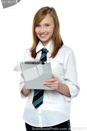 Image of Gorgeous teenager browsing on her tablet pc