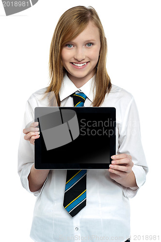 Image of Pretty college girl displaying a tablet device