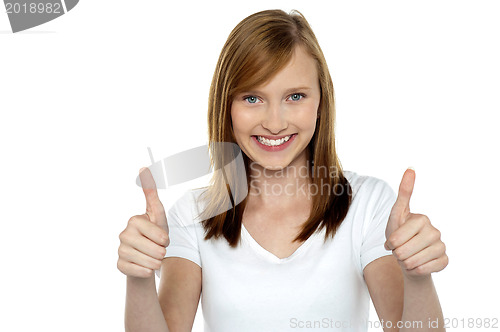 Image of Pretty teenager gesturing double thumbs up