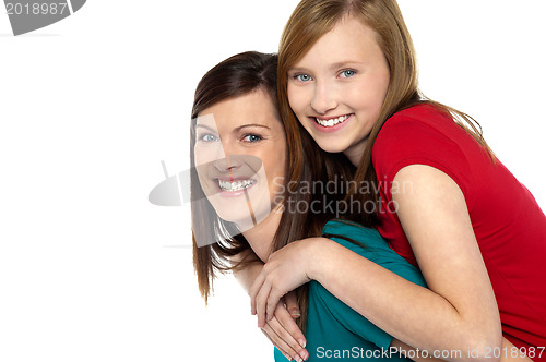 Image of Mother giving daughter ride on back