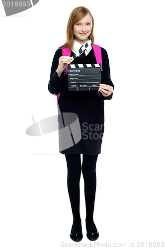 Image of Cute school girl with a clapperboard