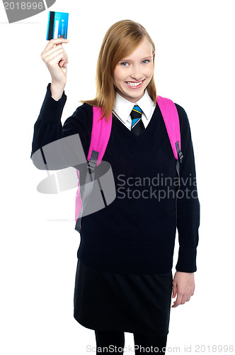 Image of Teen girl in uniform holding up a cash card