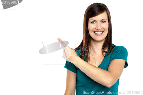 Image of Attractive lady pointing towards copy space area