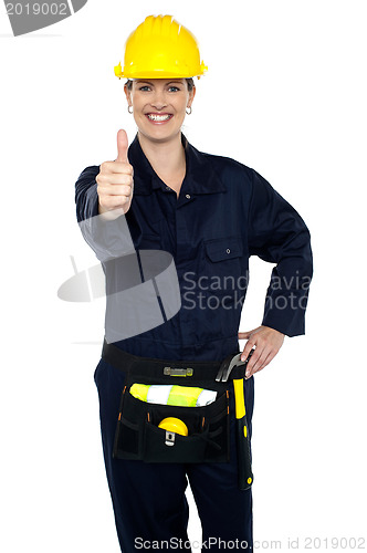 Image of Confident lady worker showing thumbs up