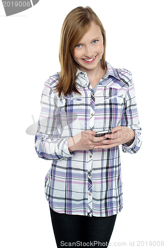 Image of Casual teen girl messaging her friends