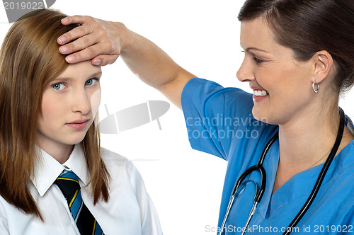 Image of Doctor placing her hand on a patients forehead