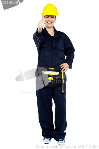 Image of Energetic construction worker in yellow helmet