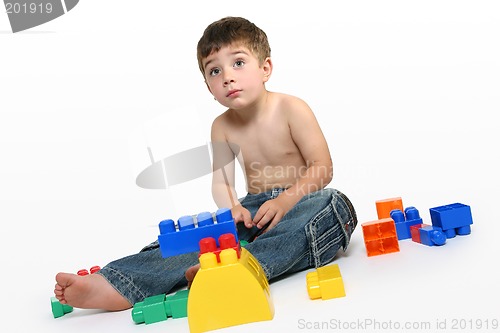 Image of Young boy amongst building blocks