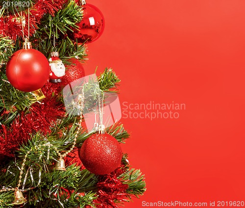 Image of Decorated christmas tree on red background