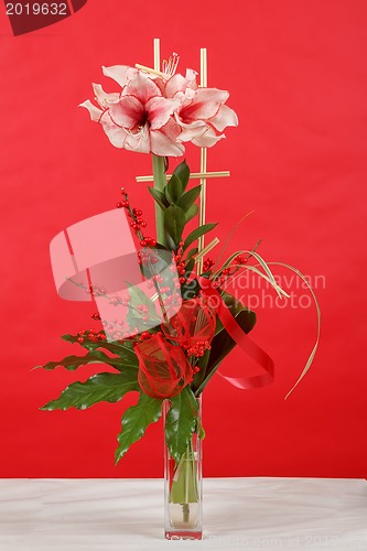 Image of bouquet of pink lily flower on red