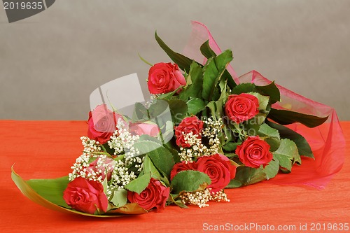 Image of Bouquet of fresh red roses on gray