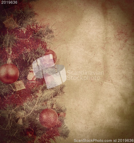 Image of grunge christmas background with balls on tree 