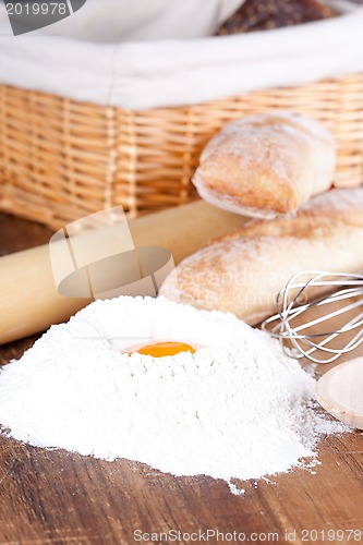 Image of bread, flour, eggs and kitchen utensil