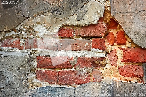 Image of Old brick wall with destroyed stucco