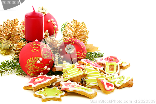 Image of Christmas cookies, red balls and golden cones.