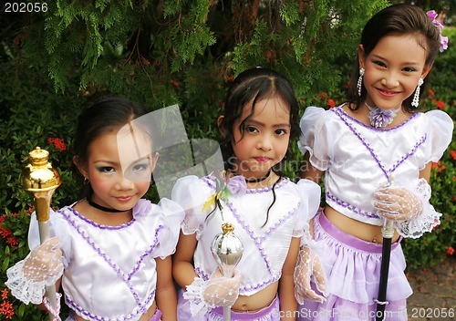 Image of Beautiful young Thai girls in purple outfits before a parade in