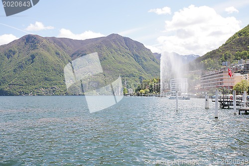 Image of Mountainside villas and appartments at lake with waterfountain i