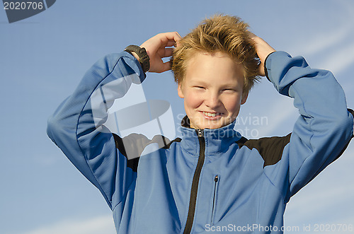 Image of Kid adjusts his hair