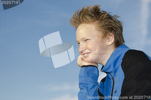 Image of Portrait of youngster against blue sky