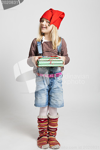 Image of Smiling girl holding Christmas gifts