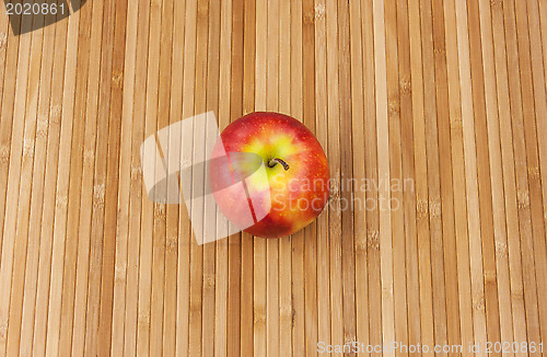 Image of apple lying on a bamboo napkin