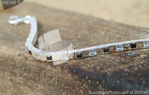 Image of Silver bracelet on a piece of wood