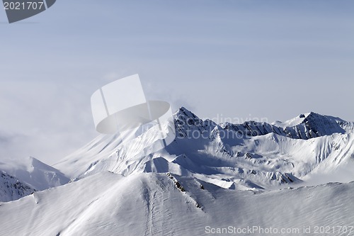 Image of Snowy mountains in fog