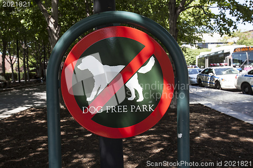 Image of A red sign  "dogs free park"