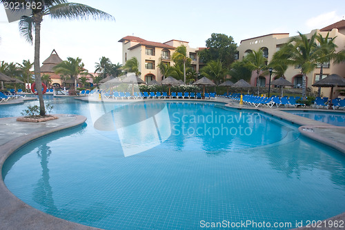 Image of Beautiful pool and patio in tropical setting 