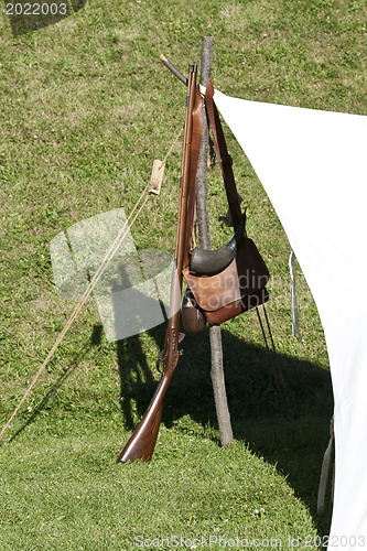 Image of Old style Gun heanging in a stiak 