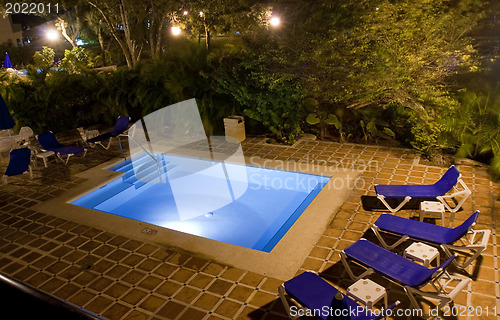 Image of Beautiful pool and patio in tropical setting 