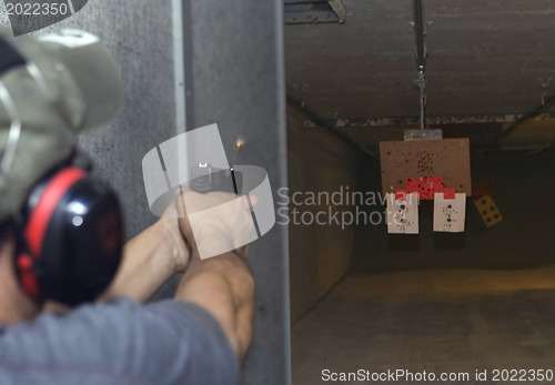 Image of Target practicing with gun In the shooting range 