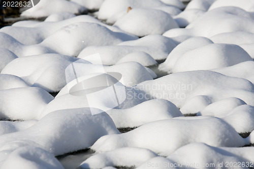 Image of Bumpy lawn covered with snow