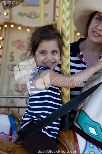 Image of Mom and Daughter on merry-go-round