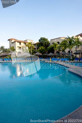 Image of Beautiful pool and patio in tropical setting 