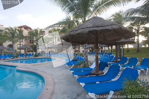 Image of Beautiful pool and patio in tropical setting 