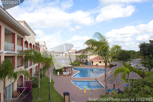 Image of Beautiful pool and patio in tropical setting 