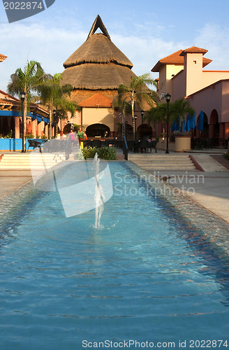 Image of Beautiful pool and patio in tropical setting 