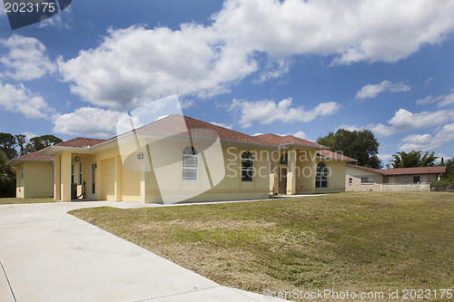 Image of Luxury family house with landscaping on the front and blue sky o