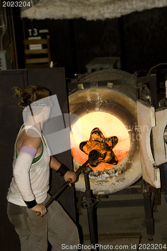 Image of Glass furnace. Glass Blower at Work