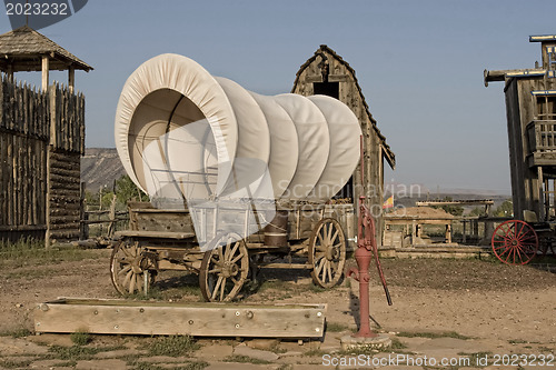 Image of Western covered wagon on yard of Fort