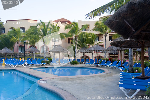 Image of Beautiful pool and patio in tropical setting 