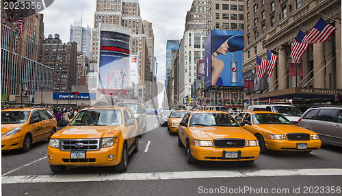 Image of NEW YORK - MAY 28: Group of yellow taxi cabs rush tourists aroun