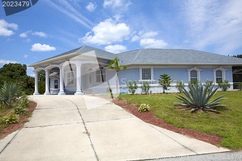 Image of Luxury family house with landscaping on the front and blue sky o