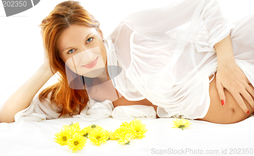 Image of smiling pregnant beauty with flowers